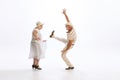 Portrait of retro style dancers, senior man and woman in vintage attire dancing swing  on white background Royalty Free Stock Photo