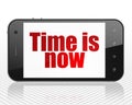 Timeline concept: Smartphone with Time is Now on display Royalty Free Stock Photo
