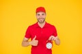 Timeliness guarantee. Promptness and punctuality. Delivery time. Delivery courier with clock. Delivery man holding clock Royalty Free Stock Photo