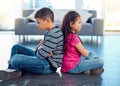 Timeout. Full length shot of two naughty young children sitting down on the floor with their backs facing each other at Royalty Free Stock Photo