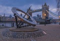 The Timepiece Sundial and Tower Bridge on Thames river in London, United Kingdom at sunset on a cloudy day Royalty Free Stock Photo