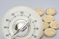 Timer in close up with group of pound coins