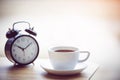 Times of coffee with alarm clock on the table Royalty Free Stock Photo