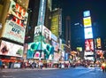 Times Square with lots of visitors at night in New York City