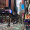 Times Square with yellow New York City Taxi cabs and tour buses driving through colorful billboards. Royalty Free Stock Photo