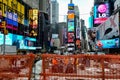 Times Square with yellow New York City Taxi cabs and tour buses driving through colorful billboards. Royalty Free Stock Photo