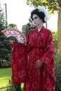 Timisoara, Romania- 09.06.2019 Living statue of a Japanese geisha. Woman dressed in kimono pose as a realistic human