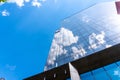 Timisoara,Timis Romania,April 24 2023: Bright clouds reflected in windows of modern office building Royalty Free Stock Photo