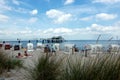 Timmendorf beach on German Baltic Sea with tourists in beach chairs and seabridge with japanese teahouse in backgrond