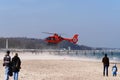 Orange rescue helicopter that has landed on the beach