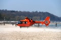 Orange rescue helicopter that has landed on the beach