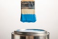Tin with blue paint and brush Royalty Free Stock Photo