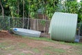 Tin Boat And Large Water Tank Royalty Free Stock Photo