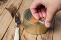 Tin can for food on wooden background. Packaging, product. Storage of food for a long time