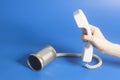 Tin can phone handset holding hand Royalty Free Stock Photo