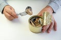 Tin can with ring in male hand. Close up. an empty label for design and text. an employee eats canned fish at work Royalty Free Stock Photo