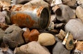 Tin can waste on pebble beach floor closeup