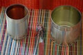 Two empty tin cans with an opener. Royalty Free Stock Photo