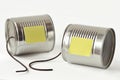 Tin cans phone with broken string and paper note - Communication Royalty Free Stock Photo