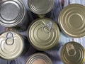 Tin cans with processed food for long-term storage, close-up. Food background