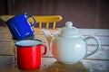 Tin coffee mugs and a teapot Royalty Free Stock Photo