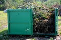 Tin container for storing biowaste from a gardening company branches of leaves and cut grass open iron painted green strongly stin Royalty Free Stock Photo