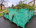 tin container for storing biowaste from a gardening company branches of leaves and cut grass open iron painted Royalty Free Stock Photo