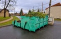 tin container for storing biowaste from a gardening company branches of leaves and cut grass open iron painted Royalty Free Stock Photo