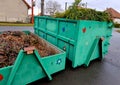 tin container for storing biowaste from a gardening company branches of leaves and cut grass open iron painted Royalty Free Stock Photo