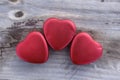 Tin hearts - Three tin hearts on wooden surface Royalty Free Stock Photo