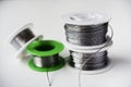 Tin-lead solder in coils on a white background. Materials for soldering