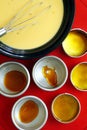 Tin molds with caramel syrup beside a Leche flan batter Royalty Free Stock Photo