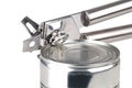 Tin opener opening a can Royalty Free Stock Photo