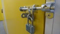 A close up of an aluminium padlock and door bolt on a self storage unit door