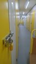 A yellow door at the end of a self storage unit corridor 2