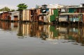 Tin shacks along a river, almost collapsing Royalty Free Stock Photo