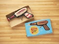 Tin toy gun in a cardboard box with vintage design packaging