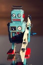 Tin toy robot carries computer circuit board, artificial intelligence concept Royalty Free Stock Photo