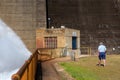 Senior man near Tinaroo Falls Dam wall, pump house and rushing w Royalty Free Stock Photo