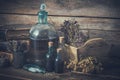 Tincture bottles, vial of homeopathy globules, old books, dry healthy herbs and curative drugs. Royalty Free Stock Photo