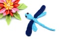 Tinker with wool and paper a crochet dragon fly and paper water Royalty Free Stock Photo