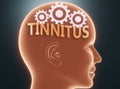 Tinnitus inside human mind - pictured as word Tinnitus inside a head with cogwheels to symbolize that Tinnitus is what people may