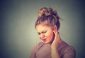 Tinnitus. Sick woman having ear pain touching her painful head Royalty Free Stock Photo