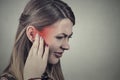 Tinnitus. Sick young woman having ear pain Royalty Free Stock Photo