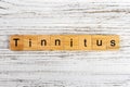 TINNITUS word made with wooden blocks concept