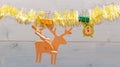 Tinsel with christmas ornaments wooden background. Merry christmas concept. Christmas ornaments and wooden deer and