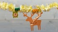 Tinsel with christmas ornaments wooden background. Merry christmas concept. Christmas ornaments and wooden deer and