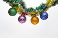 Tinsel with pinned christmas balls or ornaments, white background, copy space. Christmas ornaments concept. Balls with Royalty Free Stock Photo