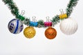 Tinsel with pinned christmas ornaments, white background, copy space. Christmas ornaments concept. Balls with ornaments Royalty Free Stock Photo