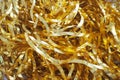 Tinsel-rain of golden color. New Year and Christmas decorations for the Christmas tree, interior or party room. Weaving